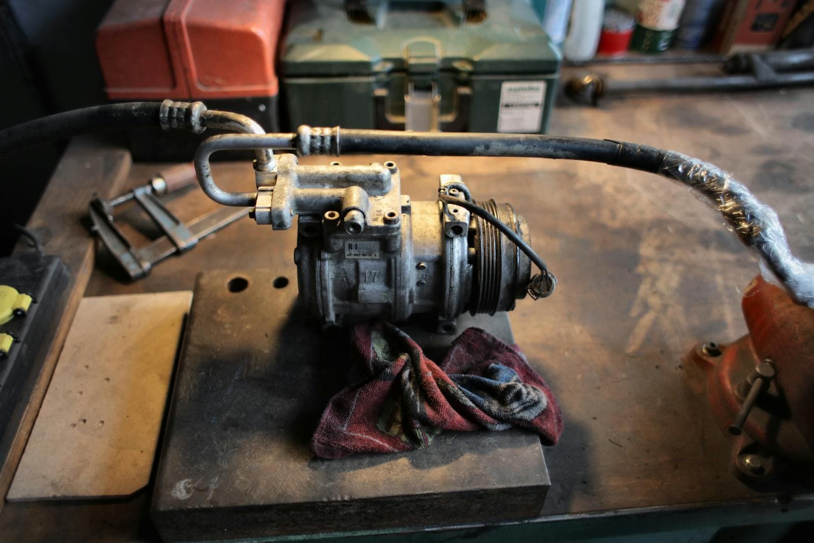 Car air conditioning compressor on the workbench during a service