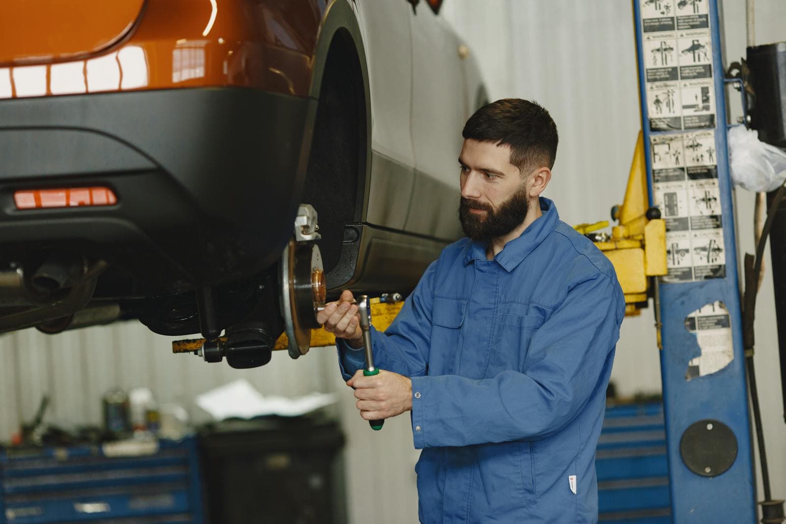 Mechanic working on car suspension components